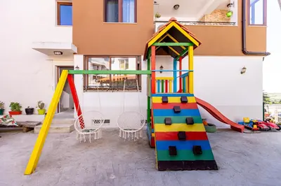 a play room with a slide and a play house at Къща за гости Калинови in Sandanski