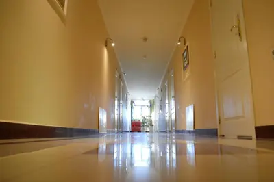 an empty hallway of a building with yellow walls at Hotel Shterev Karlovo in Karlovo