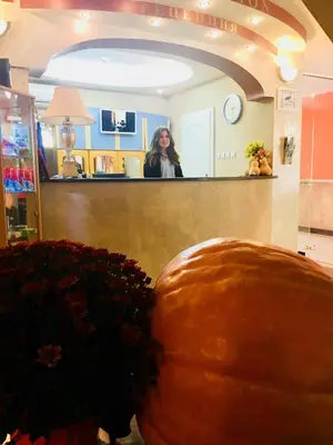 a woman standing behind a counter in a room at Hotel Shterev Karlovo in Karlovo