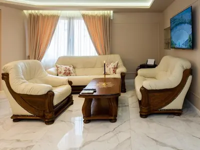 a living room with two couches and a table at Paradise Center Premium Suite 1 in Sofia
