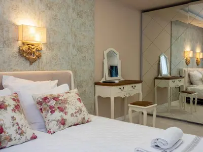 a hotel room with a bed and a mirror at Paradise Center Premium Suite 1 in Sofia