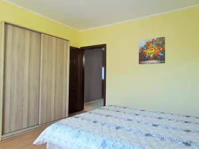 a bedroom with a bed and a painting on the wall at Апартамент за гости Dolce Vita in Gyurgevo
