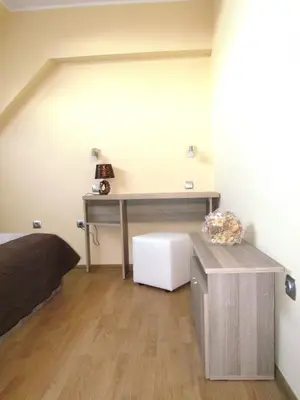 a bedroom with a desk and a bed and a table at Апартамент за гости Dolce Vita in Gyurgevo