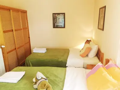 a small room with two beds in it at Къщата на Румен in Sofia
