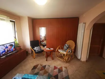 a living room with chairs and a flat screen tv at Къщата на Румен in Sofia