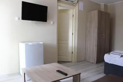 a living room with a tv and a coffee table at Бунгала Сън Сити in Sandanski