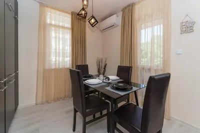 a dining room with a black table and chairs at Alma Apartment - Stylish 1BD Flat with Balcony by Flat Mаnager in Plovdiv