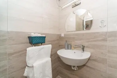 a white bathroom with a sink and a mirror at Alma Apartment - Stylish 1BD Flat with Balcony by Flat Mаnager in Plovdiv