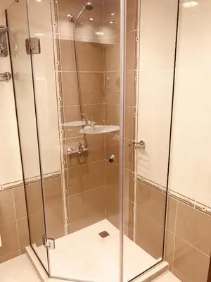 a shower with a glass door and a sink at Luxury Downtown Apartment - Gondola in Bansko
