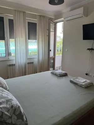 a bedroom with a bed with two towels on it at Valentina Bg Apartment in Sofia