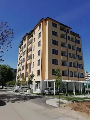 a tall building with cars parked in front of it at Valentina Bg Apartment in Sofia
