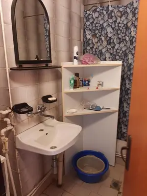 a bathroom with a sink and a mirror and a toilet at Apartment Milevi in Teteven