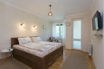 a bedroom with a bed and a tv on the wall at Apartment 