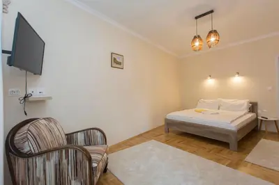 a bedroom with a bed and a tv and a chair at Apartment 