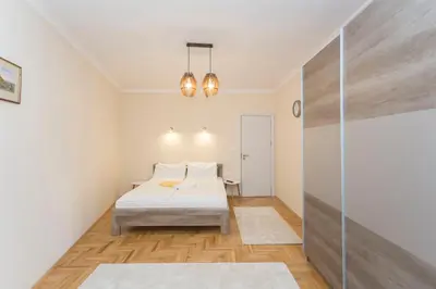 a small bedroom with a bed and a glass wall at Apartment 