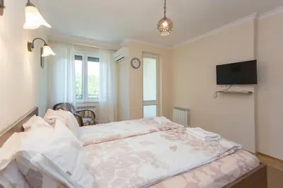 a bedroom with a bed and a tv on the wall at Apartment 