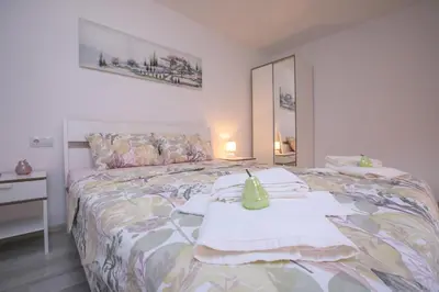 a bedroom with a bed with towels on it at The Sun loves You - right beside the Park! in Sandanski