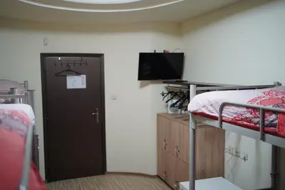 a room with a bunk bed and a door with a television at Hostel Plovdiv in Plovdiv