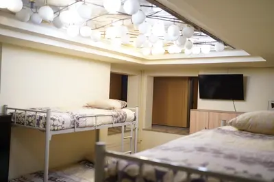 a room with two bunk beds and a flat screen tv at Hostel Plovdiv in Plovdiv