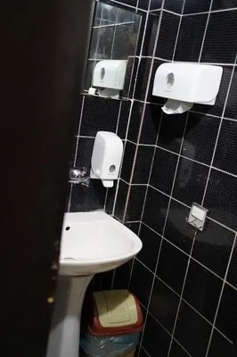 a bathroom with a toilet and a sink on a wall at Hostel Plovdiv in Plovdiv