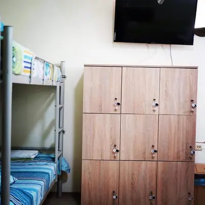 a bedroom with a bunk bed and a wooden dresser at Hostel Plovdiv in Plovdiv