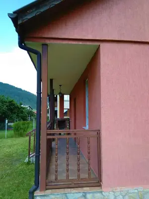 a porch of a pink building with a deck at VILLA IRINA - Govedartsi in Govedartsi