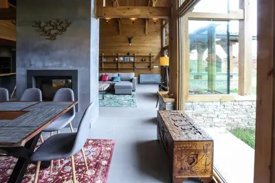 a dining room with a table and a fireplace at Mountain Hawk Park in Bansko