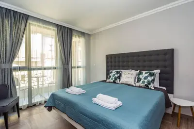 a bedroom with a blue bed with towels on it at Elegance, City center, Kapana in Plovdiv
