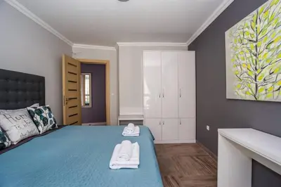 a bedroom with a bed with two white towels on it at Elegance, City center, Kapana in Plovdiv