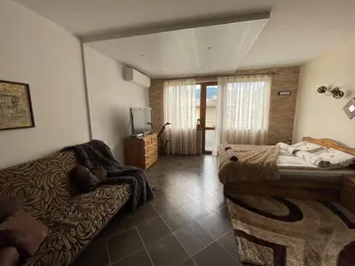 a bedroom with two beds and a tv in it at Studio Anastasia in Sapareva Banya