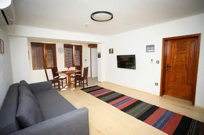 a living room with a couch and a table at Родопчани Старцево in Starzewo