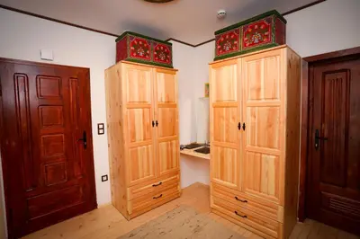 a room with two wooden cabinets and two doors at Родопчани Старцево in Starzewo