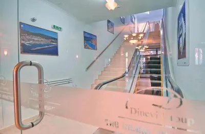 a staircase in a building with a sign that reads dimexit at Private Apartment in Grand Monastery in Pamporovo