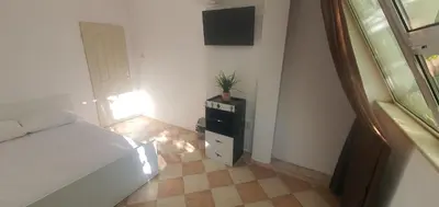 a bedroom with a bed and a plant on a dresser at ПАИ Хост in Plovdiv