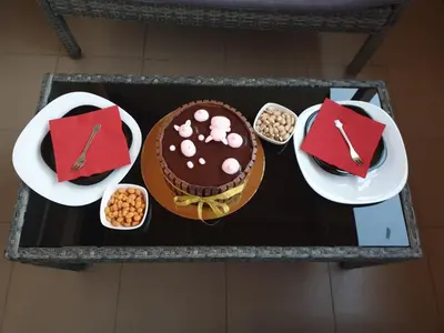 a table topped with a chocolate cake and other foods at Cosy Charming Apartment in Blagoevgrad