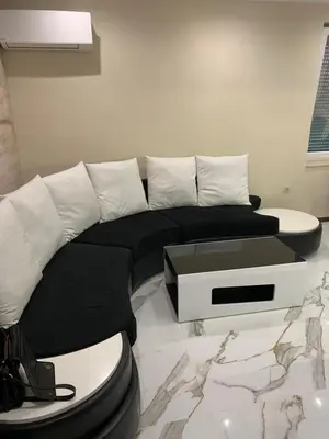 a living room with a black and white couch at Патилови in Sandanski