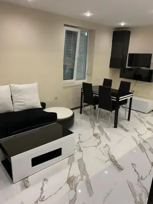 a living room with a couch and a table at Патилови in Sandanski