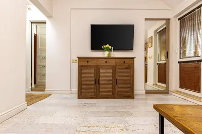 a living room with a tv on a wall at Stylish 1BD Flat with a terrace near the centre of Plovdiv by Flat Mаnager in Plovdiv
