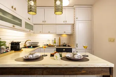 a kitchen with a counter with two plates and wine glasses at Stylish 1BD Flat with a terrace near the centre of Plovdiv by Flat Mаnager in Plovdiv