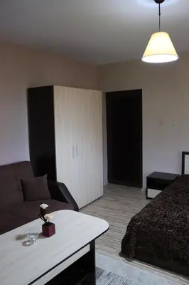 a living room with a bed and a couch at GREEN HOUSE - Попниколови in Sapareva Banya