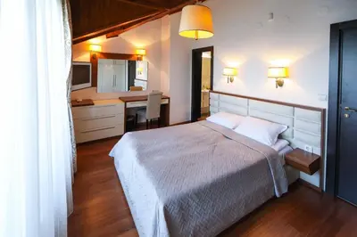 a bedroom with a large bed and a kitchen at Lake View House in Bansko