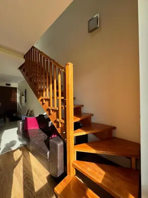 a living room with a staircase and a couch at Sunny Duplex, Mountain Views, Spa Access, Near Bansko, Terra Complex in Razlog