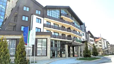 a large building with a balcony on a street at Apartments B06 in TERRA complex in Razlog