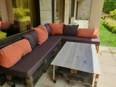 a couch and a coffee table on a porch at Apartments B06 in TERRA complex in Razlog