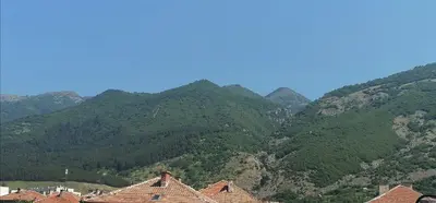 a group of houses in front of a mountain at Роден Край Homeland in Sopot