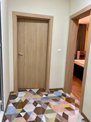 a room with a door and a colorful floor at Boutique Magenta Gold Apartment in Sofia