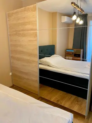 a bedroom with a large mirror and a bed at Boutique Magenta Gold Apartment in Sofia