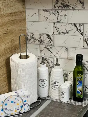 a group of toilet paper on a shelf in a bathroom at Vega Apartment in Velingrad