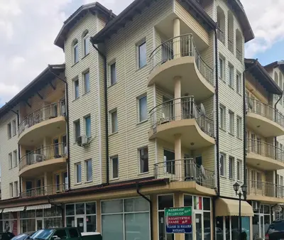 a large building with balconies on the side of it at Vega Apartment in Velingrad