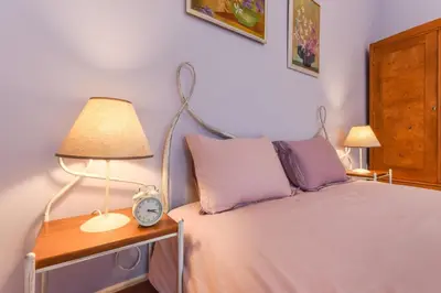 a bedroom with a bed with a lamp and a clock at Chez Marie - Cozy One-Bedroom with Balcony by Flat Mаnager in Sofia
